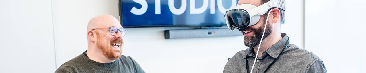 user with a virtual reality headset pictured and smiling